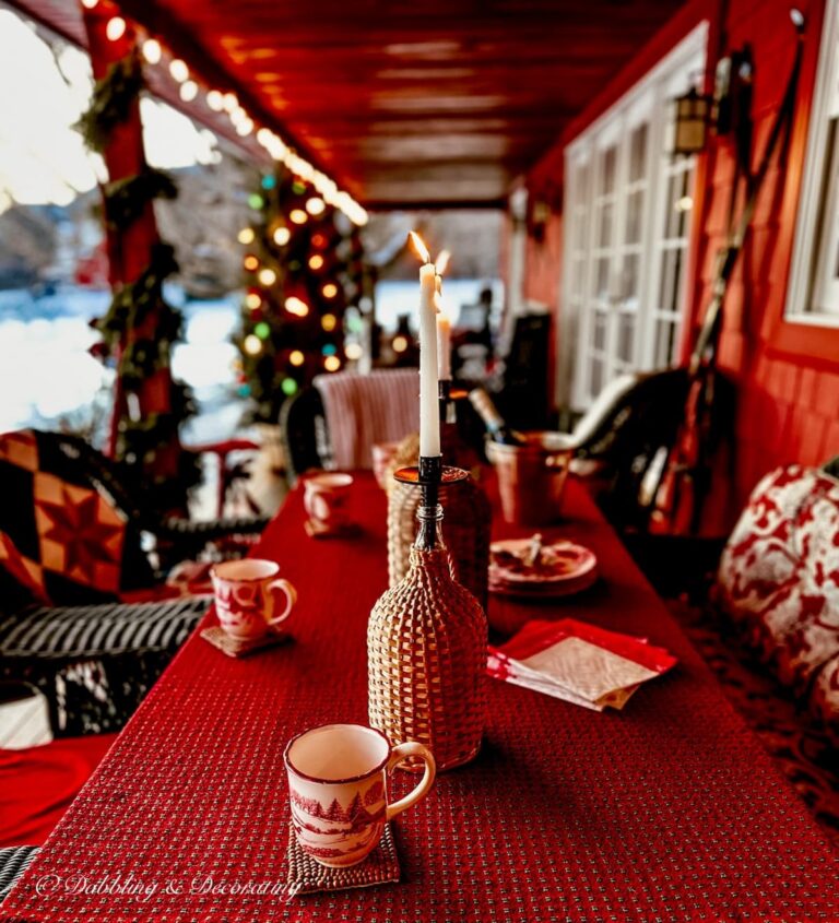 Vintage demijohn bottles with candles on red styled apres ski theme party porch.