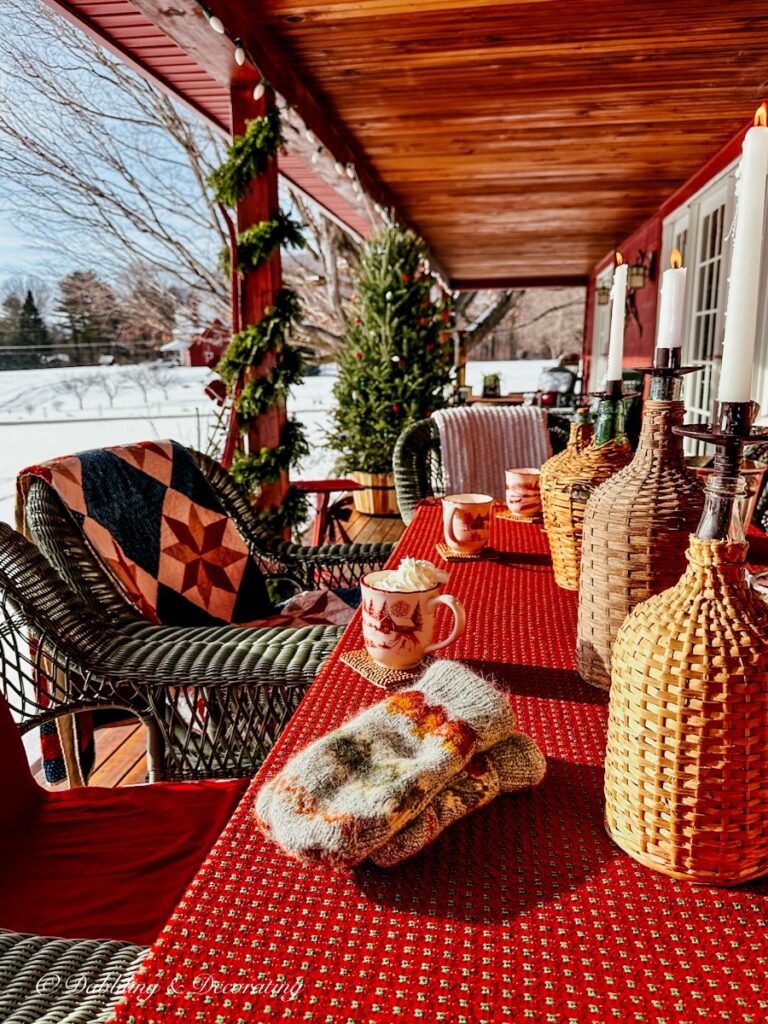 Blue and red quilt on outdoor Après Ski Theme table on Christmas style porch.