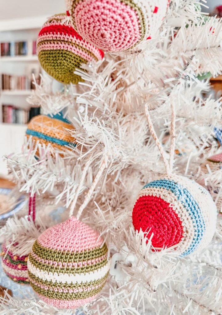 Vintage white Christmas tree with vintage embroidered ornaments as Simple winter table decorations.