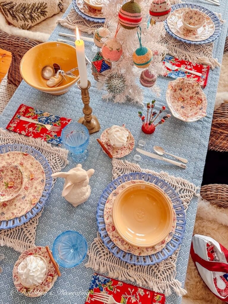 Blue and yellow winter tablescape with vintage Chintz place settings on blue tablecloth for Christmas as Simple winter table decorations.