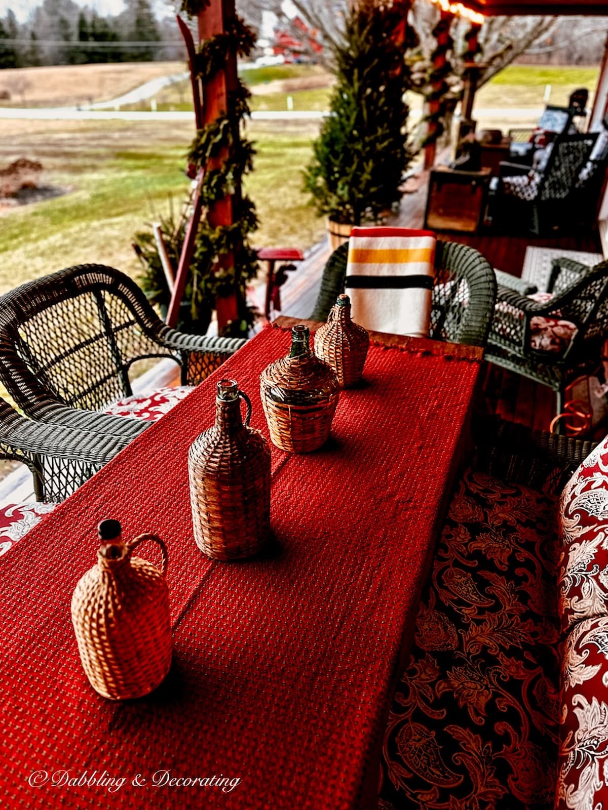 Red Mountain Weaver table cloth on outdoor porch table for Christmas.