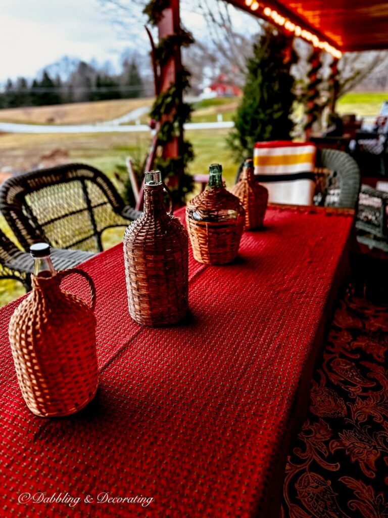 Red Mountain Weaver table cloth on outdoor porch table for Christmas for Simple winter table decorations.