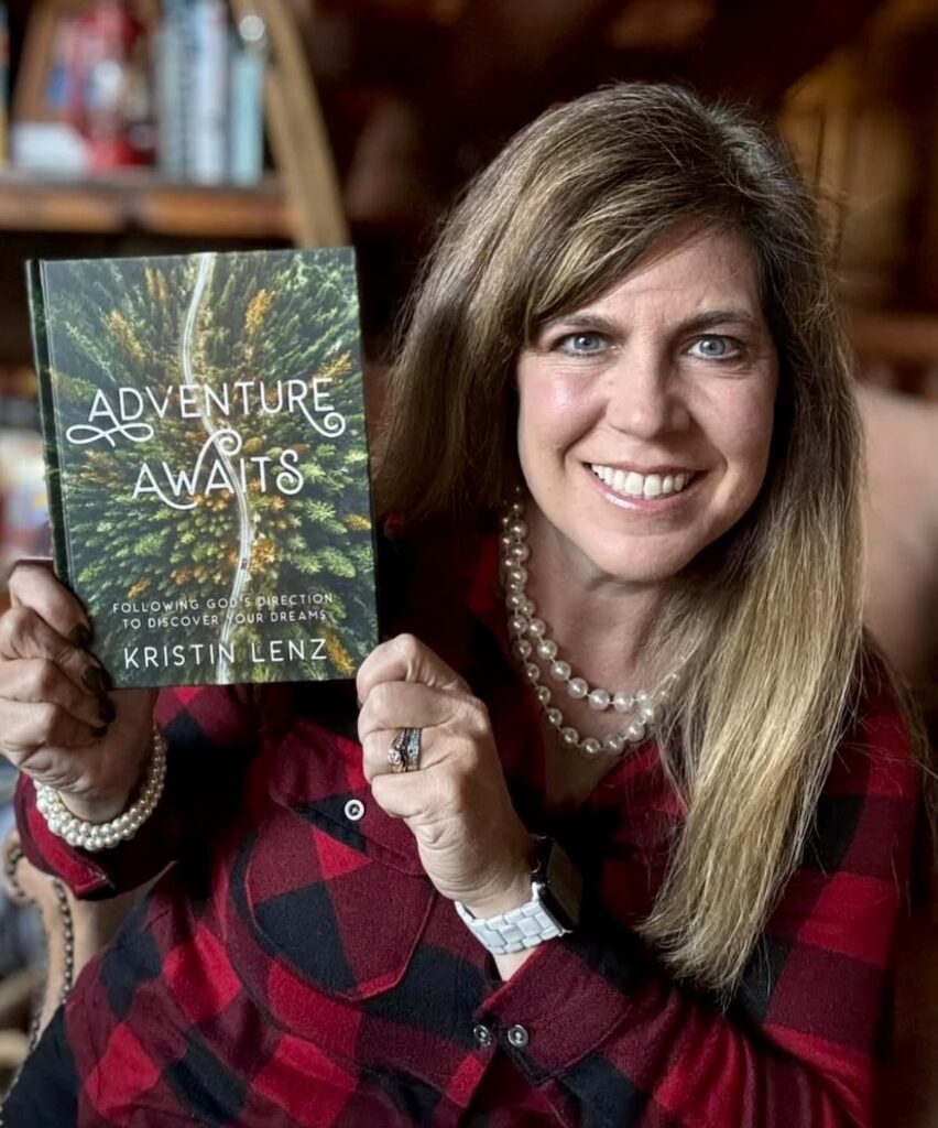 Kristin of White Arrows Home Holding Her Book Adventures Await.