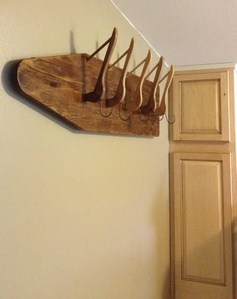 DIY Coat Hanger on wall with vintage ironing board and wooden hangers.