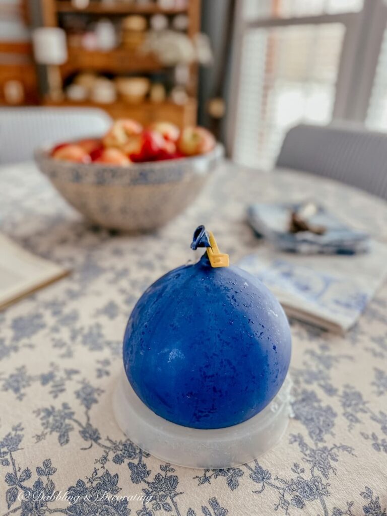 Blue balloon on ice tray on table creating an Ice Lantern.