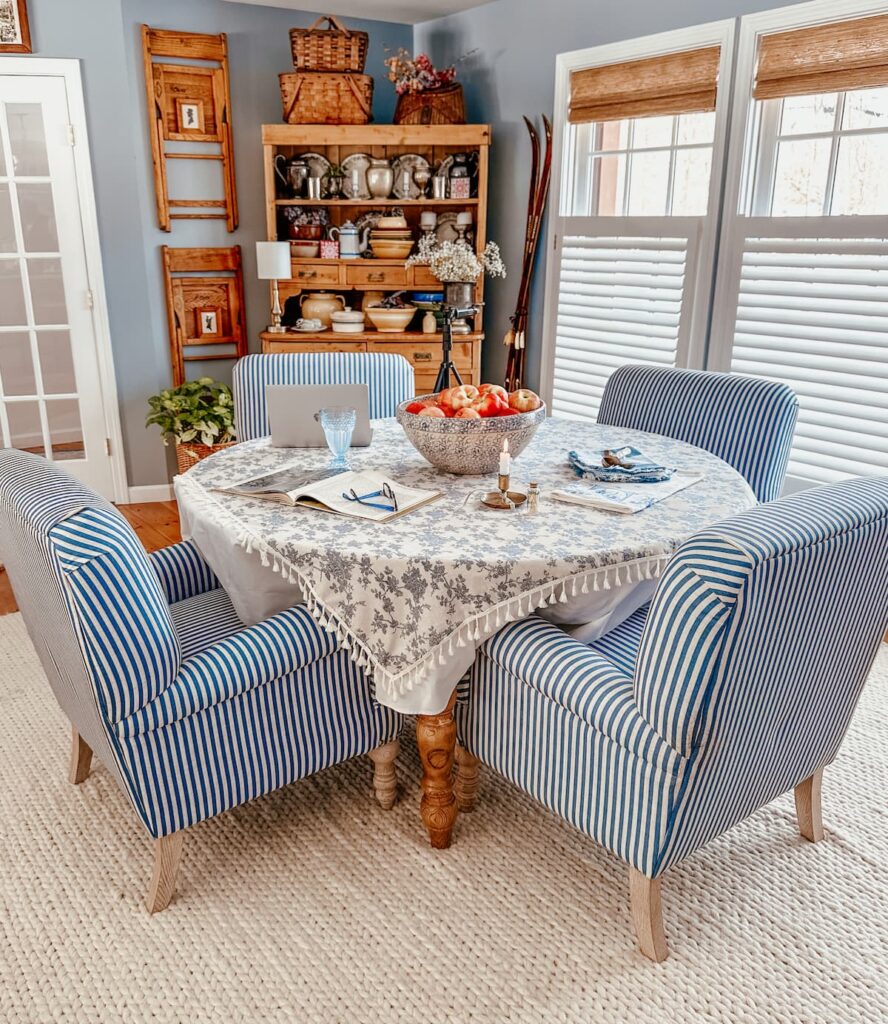 Blue and white dining room table set with laptop, tripod, glasses, book etc. working on bamboo shade collaboration with TWOPAGES