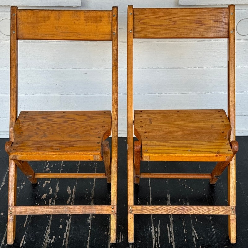 Two retro wooden folding chairs.