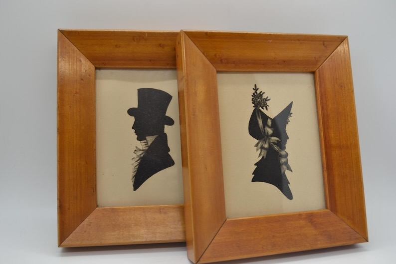 Two vintage wall art wooden framed portraits.