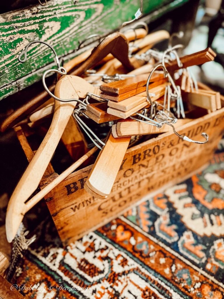 Collection of vintage wood clothes hangers in an old crate.