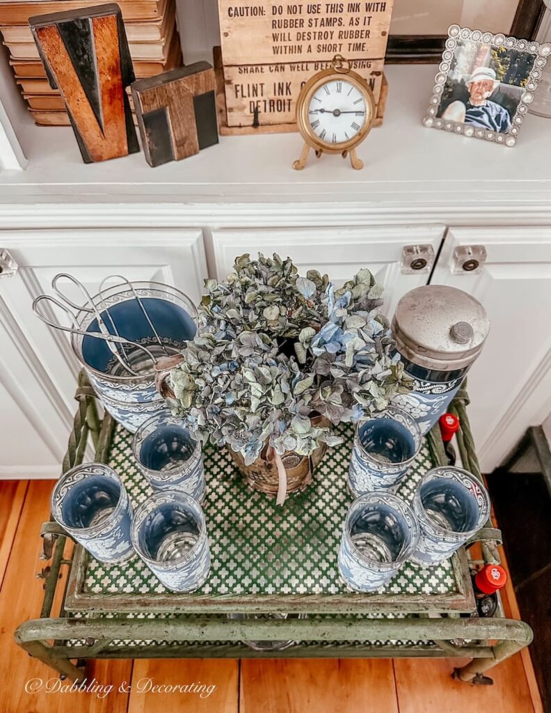 Vintage blue Jeanette Bar Set on antique bar cart.