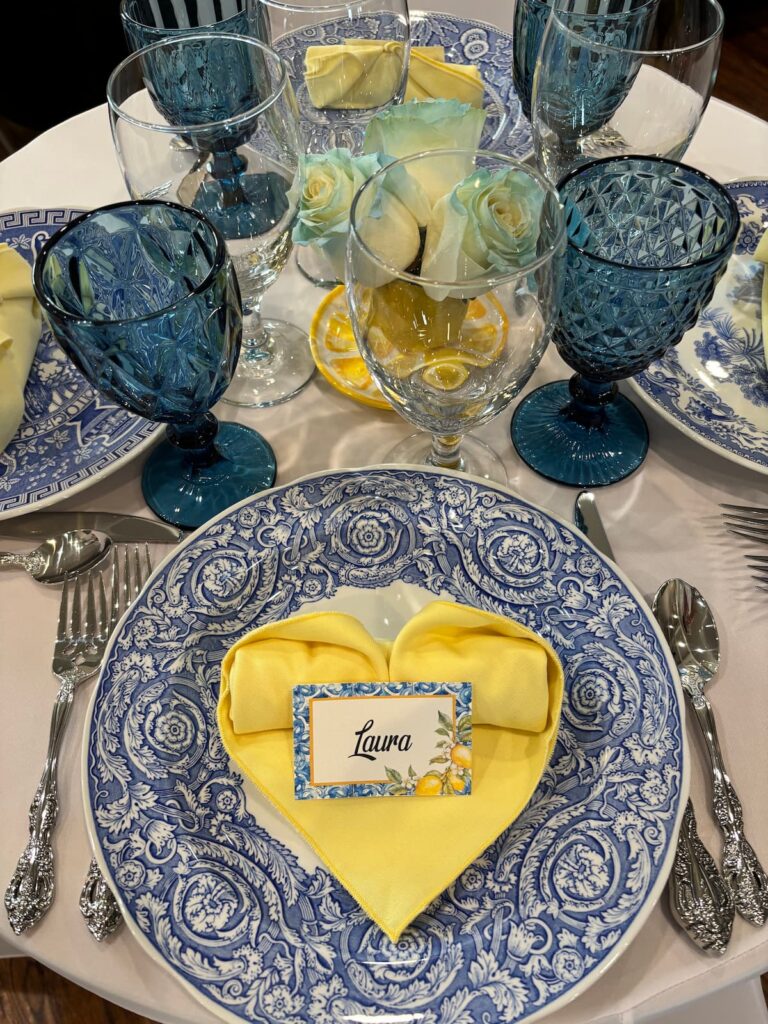 Blue and white vintage place settings on eclectic interiors table.