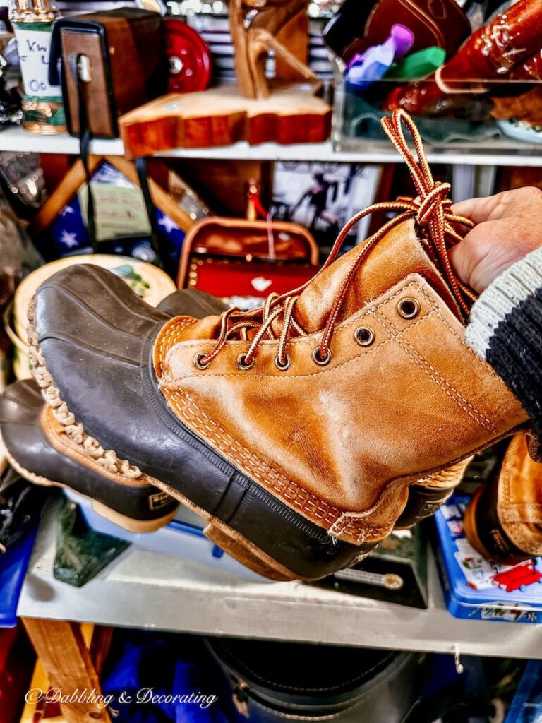 L.L. Bean boots in hand at thrift store.