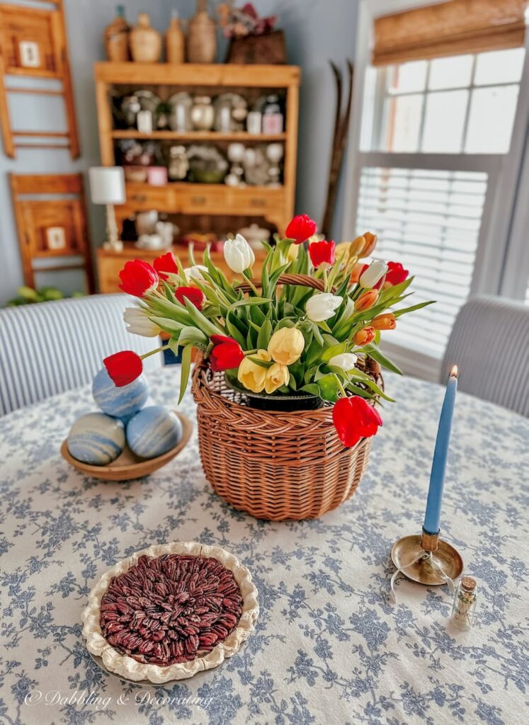 Basket of colorful tulips on blue and white styled dining room eclectic interiors.