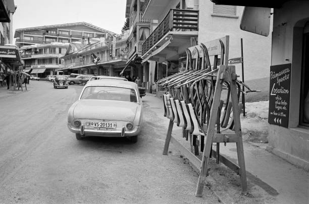 Black and white photo of ski resort with schibobbing rack filled with Schibobs.